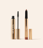 Effortless Gaze Duo featuring Gilded Lashes Mascara and Mauve Eye Perfecting Shimmer Stick in elegant gold packaging.