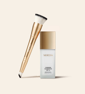 Meroda Cosmetics Changing Foundation SPF 15 and gold 2-in-1 Brush for fair to medium skin tones on a light background.