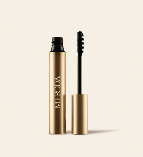Meroda Cosmetics The Precision Brow Gel in an open gold tube with a silicone applicator brush on a light background