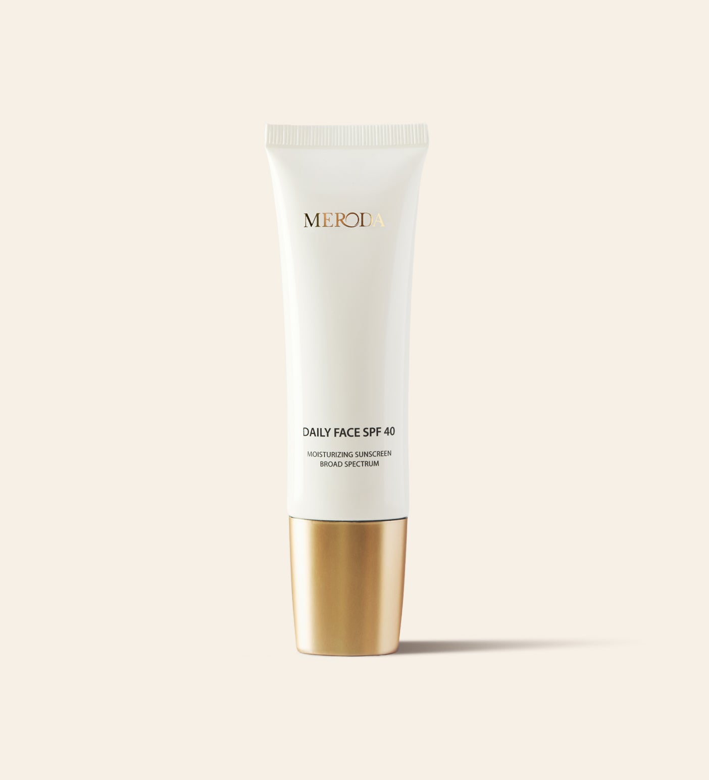 Daily Face SPF 40 broad-spectrum moisturizing sunscreen in a sleek white tube with a metallic gold cap.