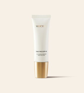 Daily Face SPF 40 broad-spectrum moisturizing sunscreen in a sleek white tube with a metallic gold cap.