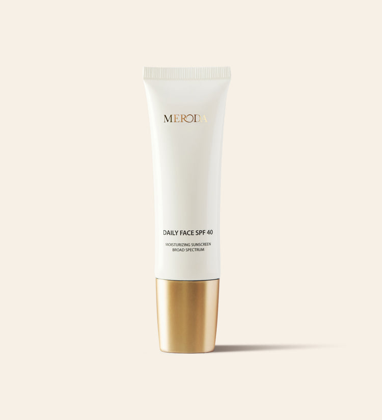 Daily Face SPF 40 broad-spectrum moisturizing sunscreen in a sleek white tube with a metallic gold cap.