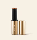 Meroda Cosmetics Soft Tan Bronzer in shade Dark, a creamy stick in gold and black packaging for a natural sun-kissed glow.