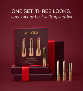 Mini Lip Tint Trio con tres tintes labiales hidratantes en envases dorados junto a una caja de regalo con cinta roja.