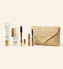 Summer Travel Icons set featuring SPF 40, foundation, lip tint, and mascara with a beige woven raffia clutch.